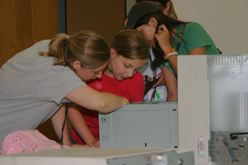 Photos of girls taking apart a computer