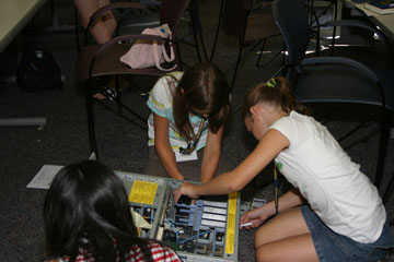 Photos of girls taking apart a computer