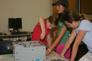 Photos of girls taking apart a computer