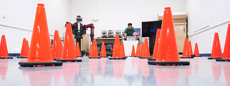 A student building a robot obstacle course
