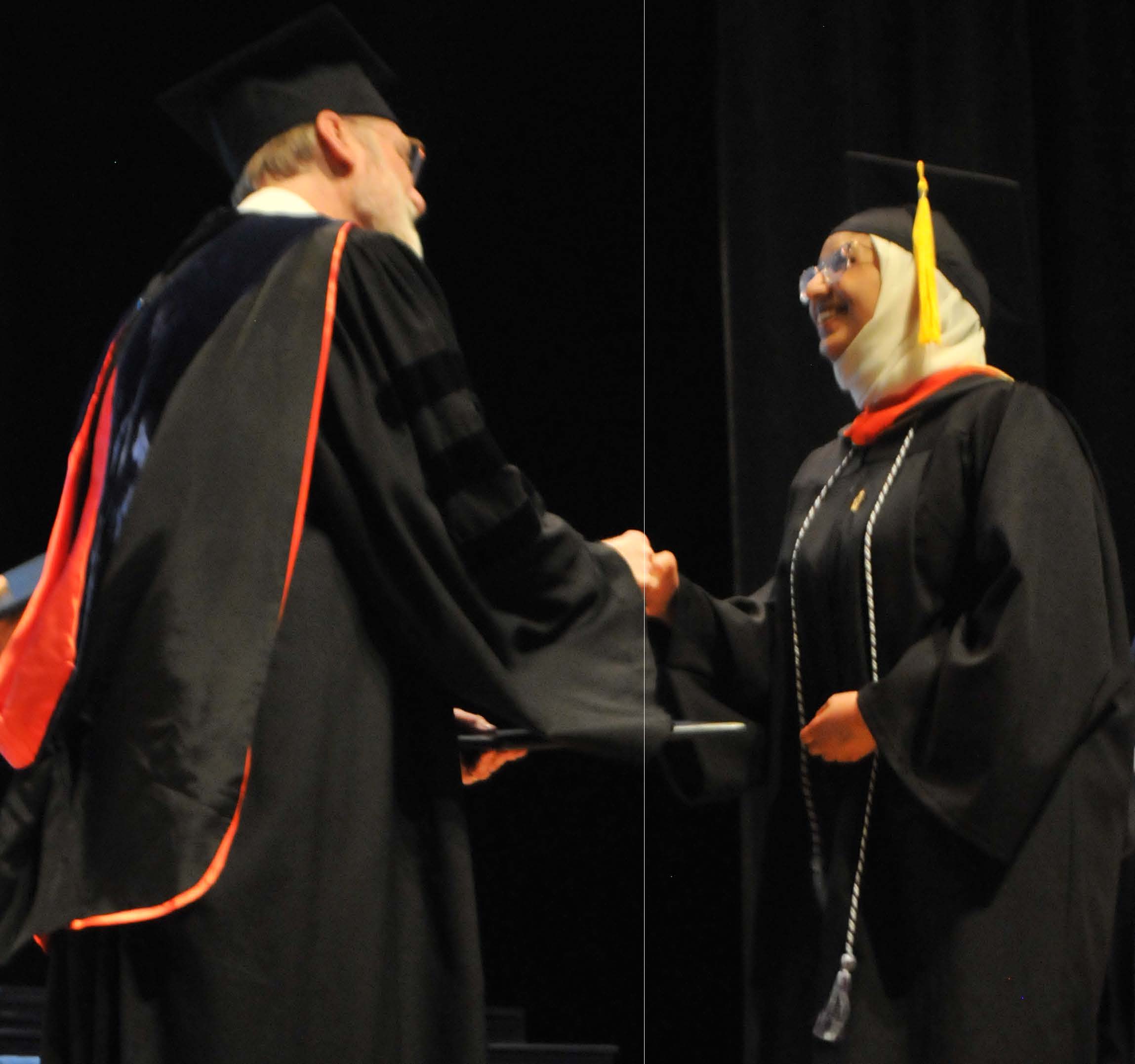 student shaking faculty's hand