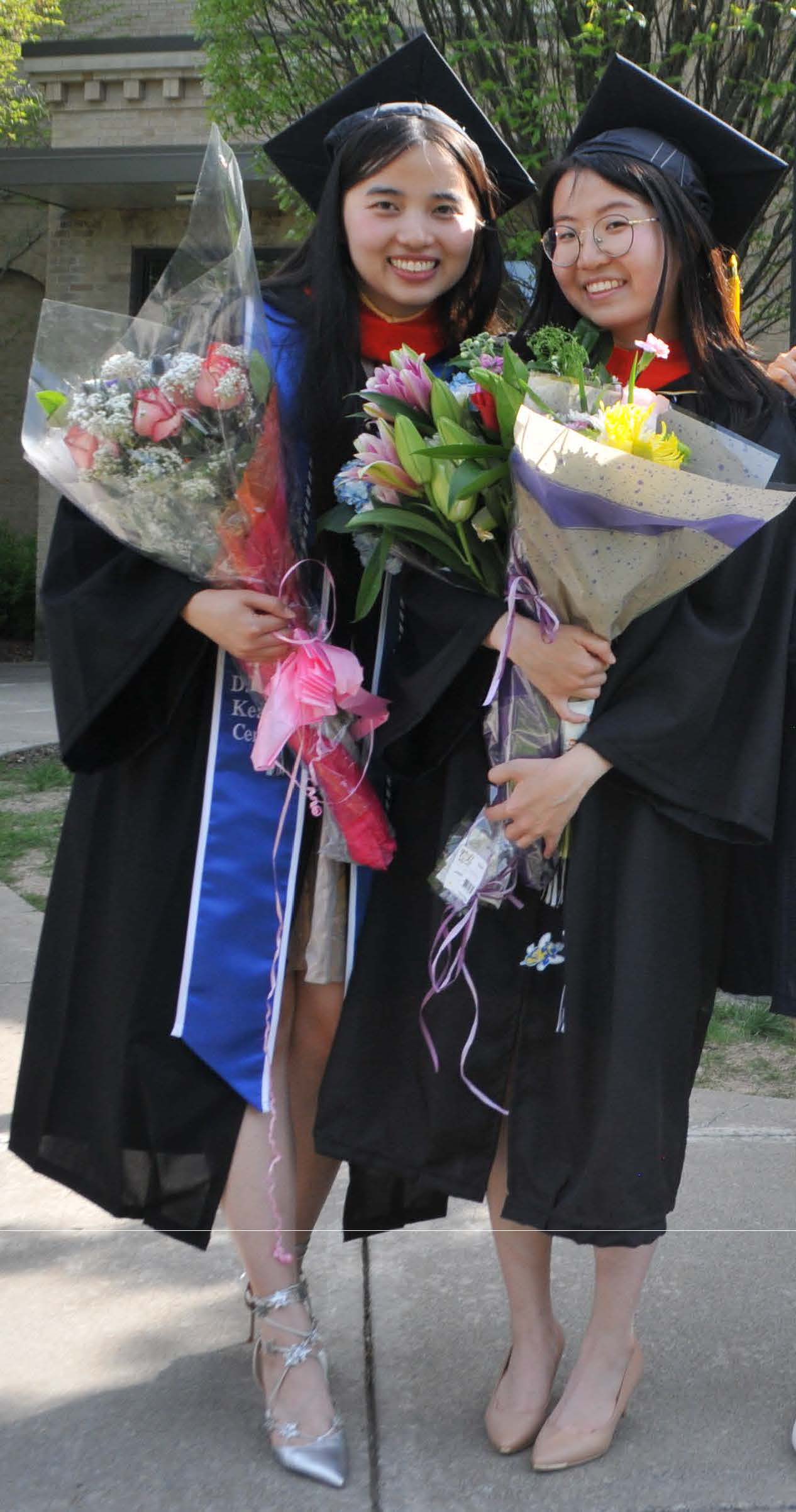 two students w/ flowers