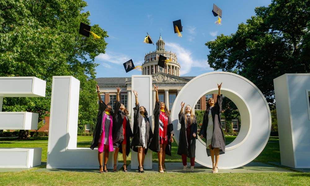 Undergrads throwing caps in front of library (Matt Wittmeyer)