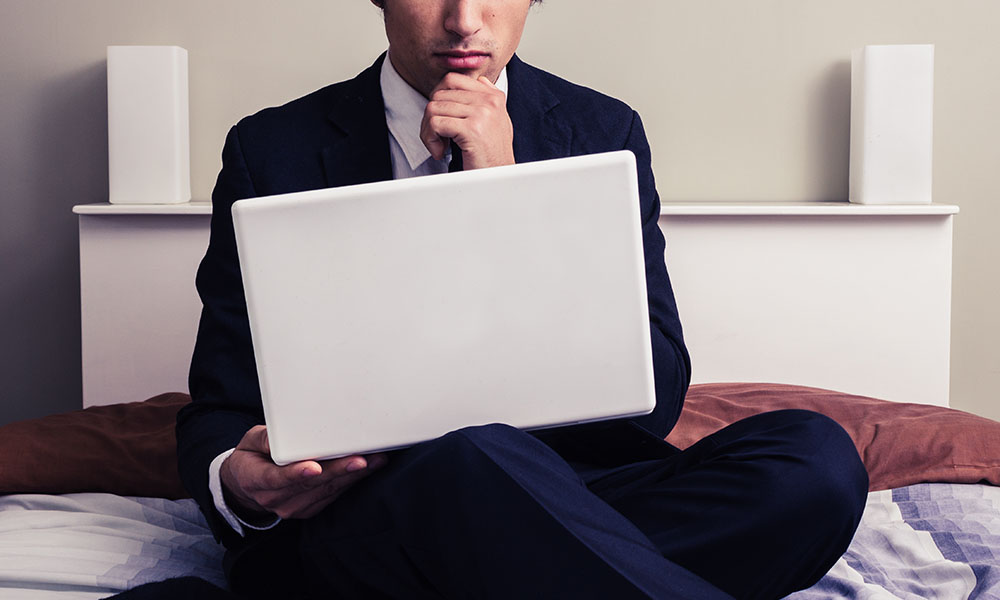 Man reading on laptop, looking skeptical, as way to show media bias.