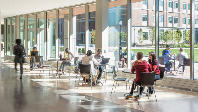 students at cafe tables in Wegmans Hall 