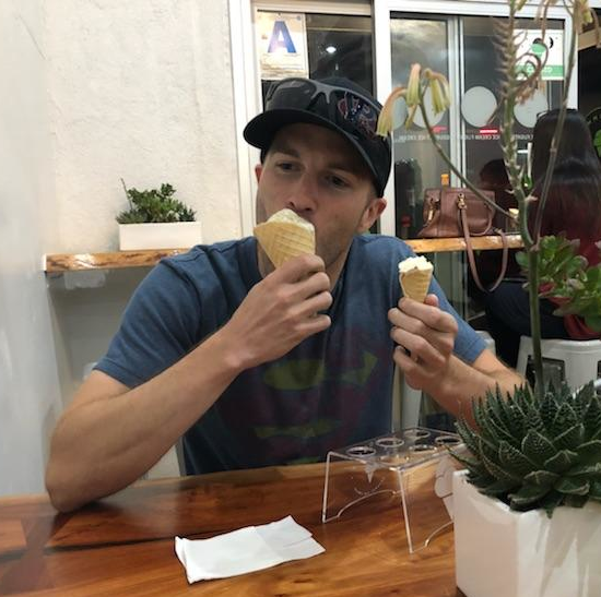 Photo of Ian Ward eating ice cream with a cone in each hand>
            <ul class=