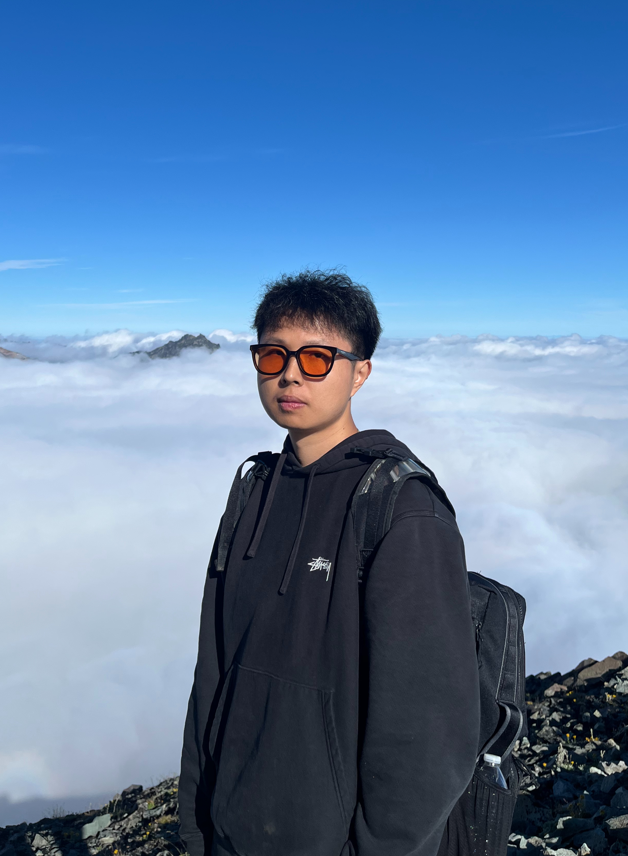 Mingqian on mountaintop above clouds