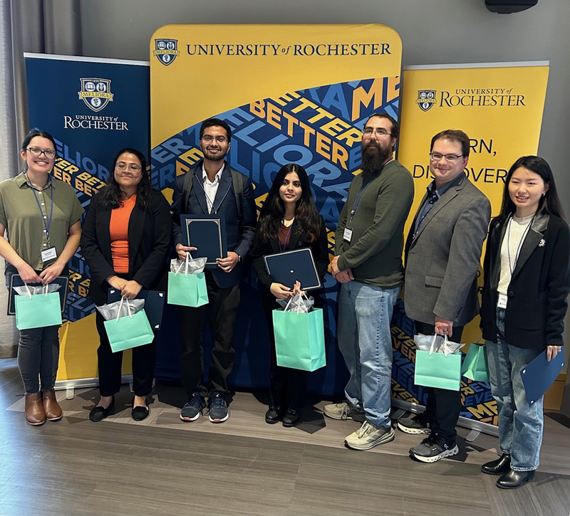 Research winners holding awards