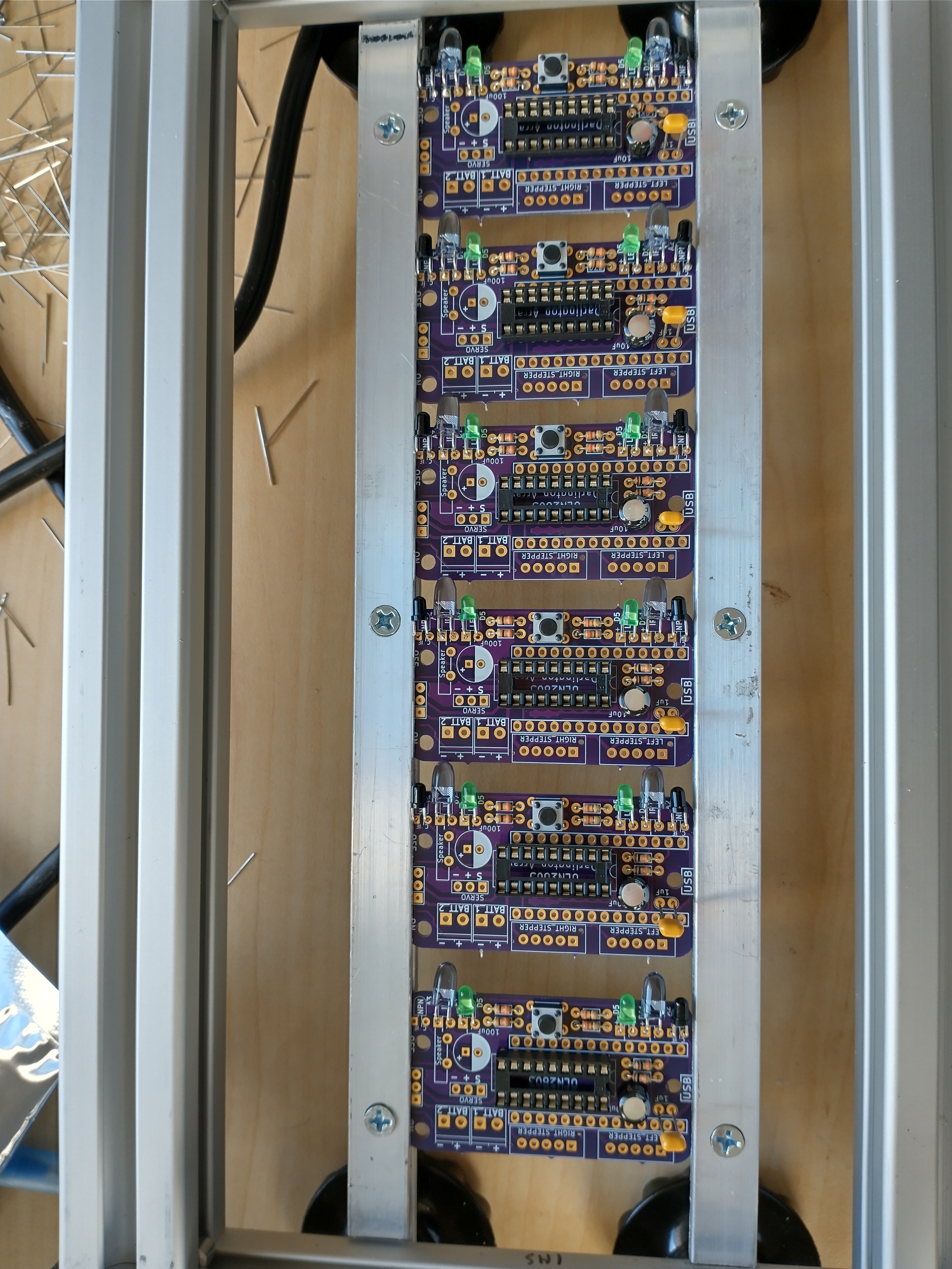 Image of the fixture with 6 PCBs partially assembled.